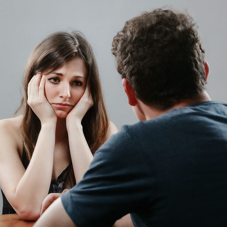 a sad woman trying to talk to her boyfriend